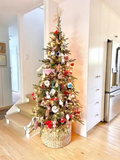 Smalle kerstboom in hoek van keuken naast bijkeuken en trap