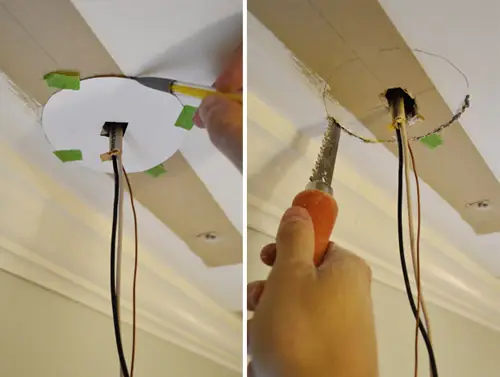 Gat in plafond zagen voor verlichtingskast met behulp van een prikzaag