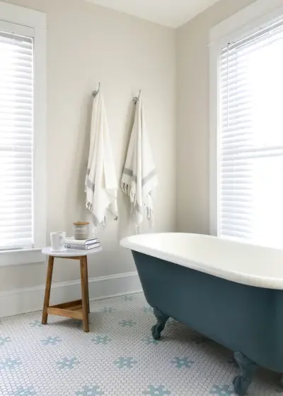 Witte badkamer met marineblauw afgewerkt bad op pootjes