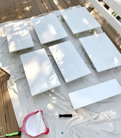 Kastdeuren op hangdoek gelegd met een laag witte primer die droogt