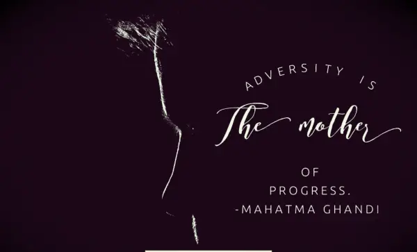The profile of a person sitting in the dark while facing emotional adversity.