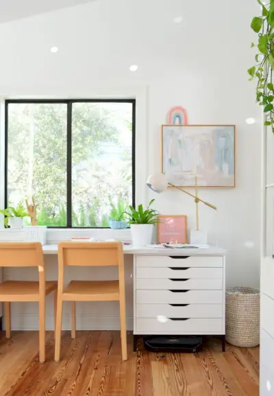 Kinderkunstbureau gemaakt van Ikea-dressoirs en laminaatmarmeren aanrecht met houten stoelen
