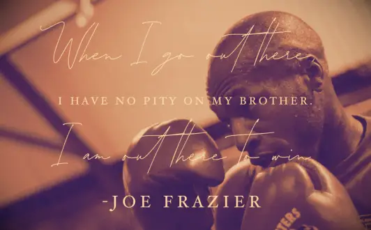 A boxer behind his gloves thinking of a Joe Frazier quote to get inspired