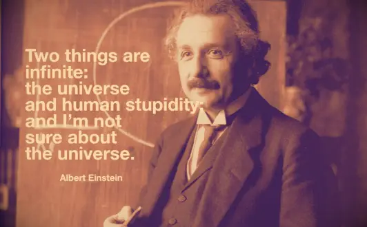 Albert Einstein writing on a board wile lecturing on the Theory of Relativity