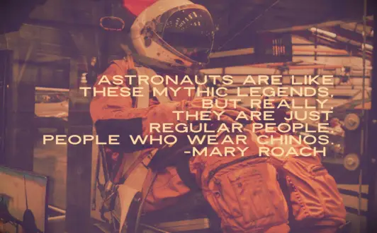 An astronaut in an orange space suit in a training simulator at NASA in Houston