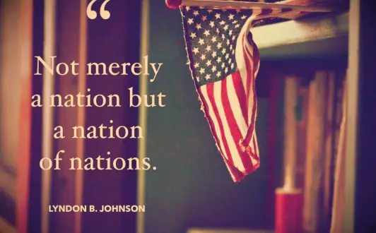 USA quote from President Johnson and a mini American Flag resting on a shelf