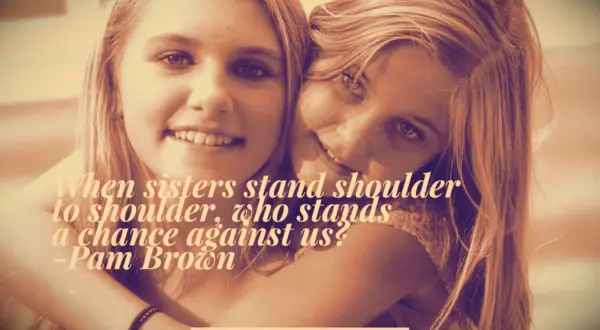 Two blonde sisters smiling with their arms around each other for a photo