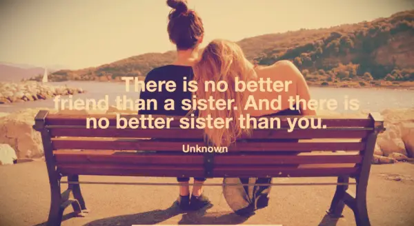 A blonde girl leaning on her brunette sister