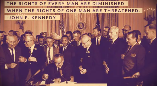 LBJ signing the Civil Rights Act into law in a crowded room of politicians