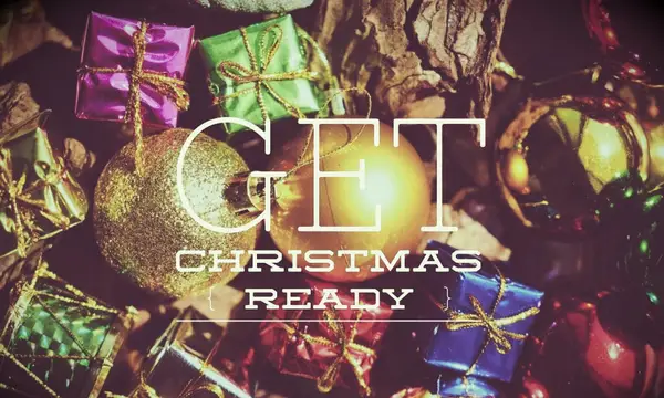 Several brightly colored Christmas gifts and gold ornaments by a tree