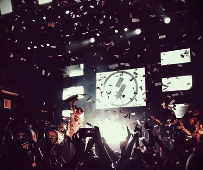 A band singing inspirational songs on stage at a live concert.