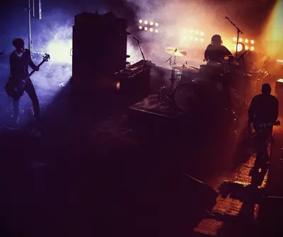 An inspirational band playing on a smoky stage.