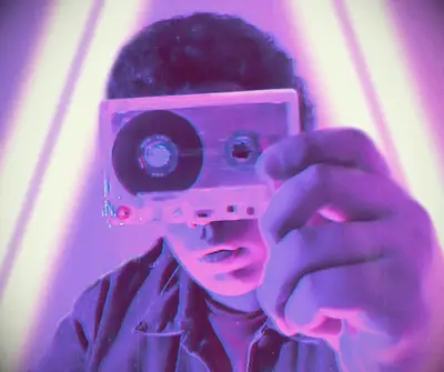 A man holding an inspirational mix tape.