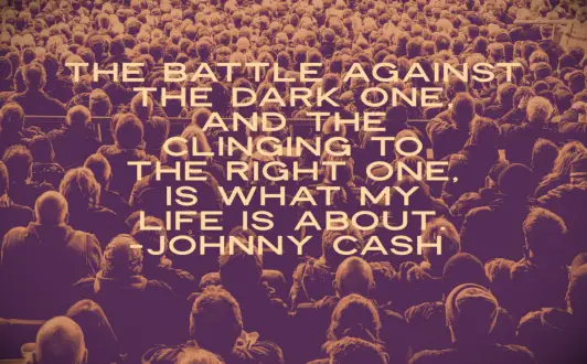 An audience of hundreds of people all facing a stage off camera