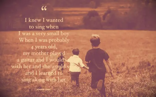 Three young brothers running through a rye field together in Pennsylvania